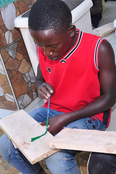 One boy doing carpentary works